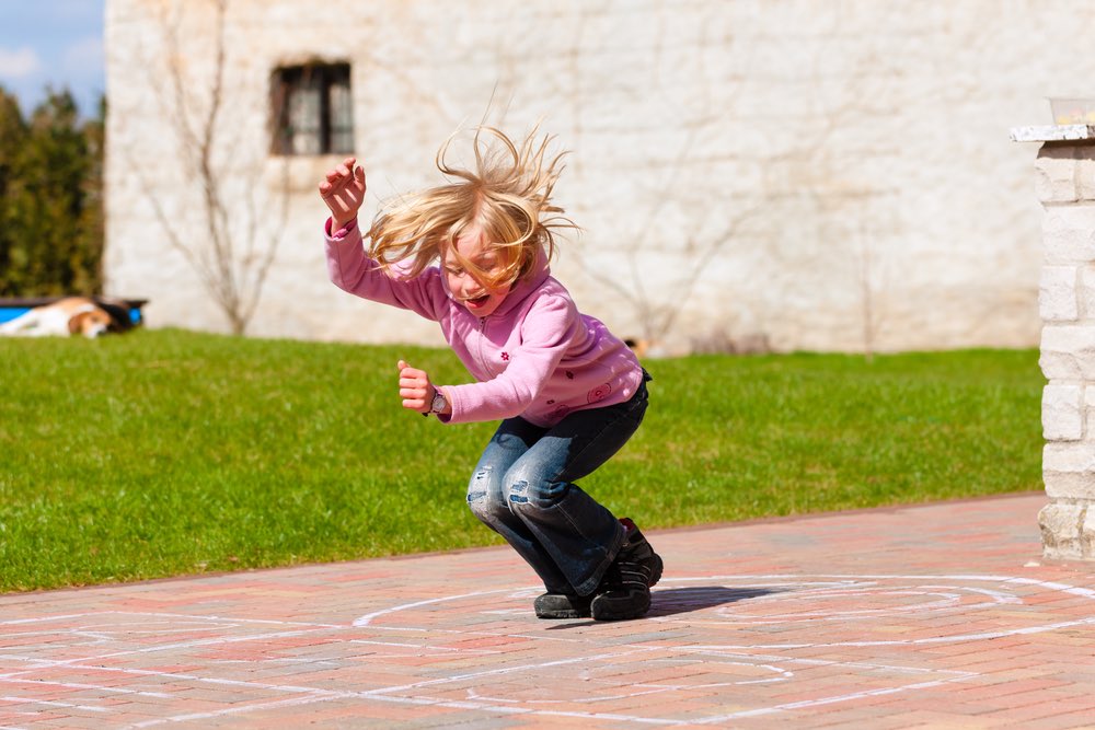 Girl Playing hopscotch