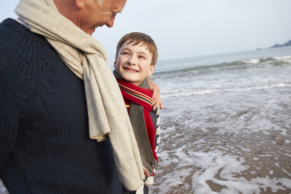 Grandfather and Grandson walking on winter beach