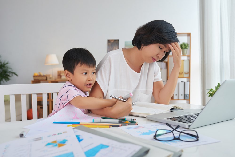 Boy Interfering with Mom's Work