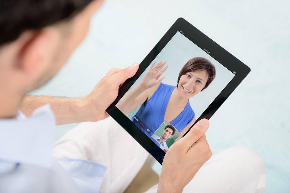 Man talking with Woman on IPad