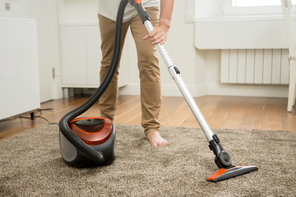 Young Adult Vacuuming